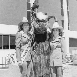 An historical photo of students with a bronco mascot.