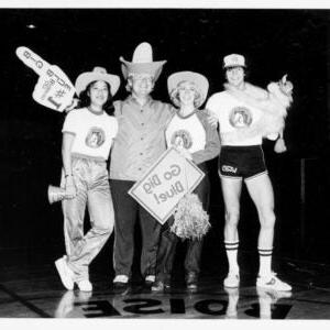 An historical photo of students with hats and pom poms.