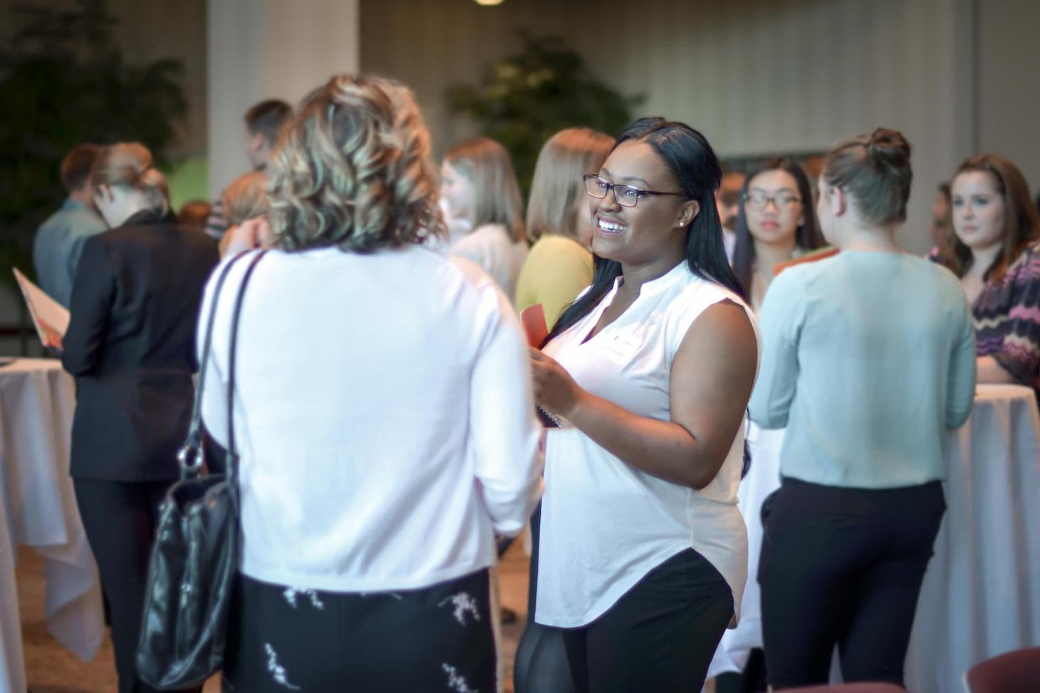 Student talking with an employer at a networking event