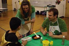 students painting with child